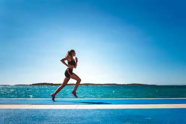 Woman running showing strong leg muscle Beccles